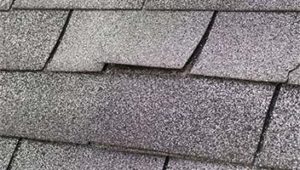 Wind damage to shingles on roof